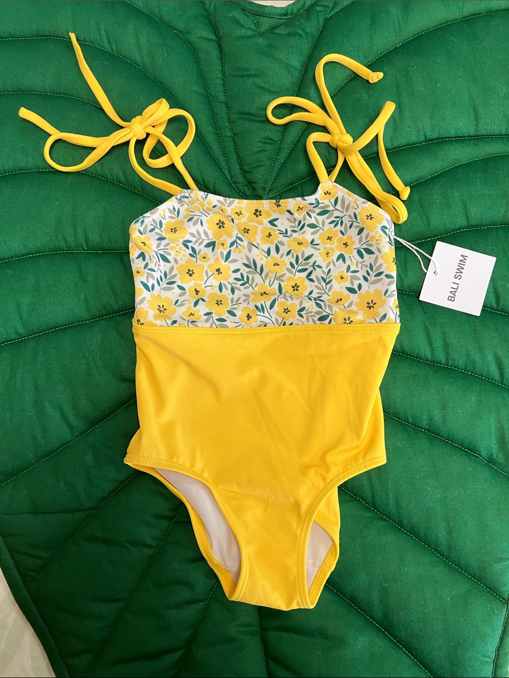 NWT Bali swim girls one piece yellow floral print swimsuit. Tie straps. Size 2-4